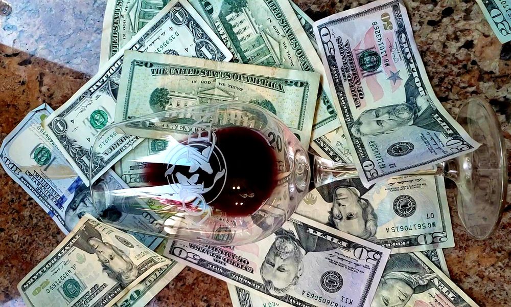 Picture of Wineglass on top of money